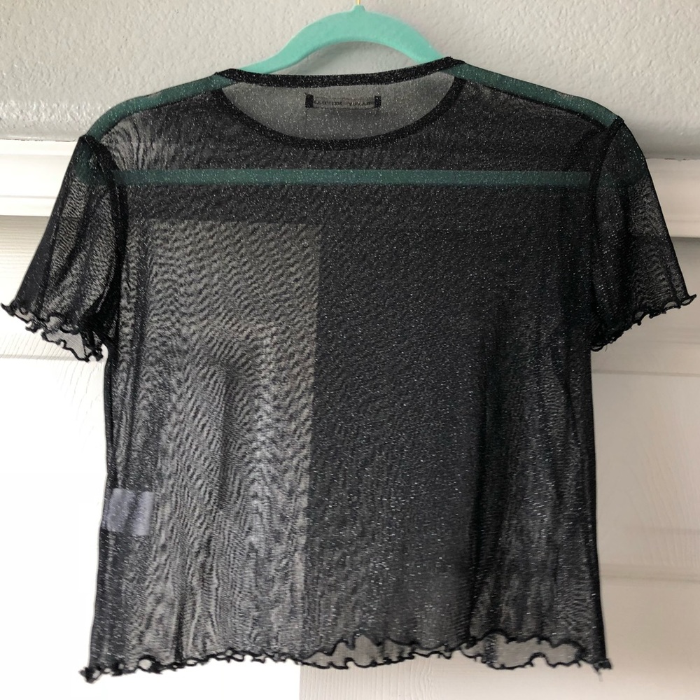 a see through sparkly shirt
